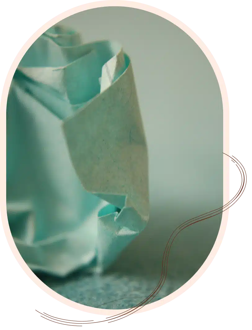 A close-up of a crumpled piece of light blue paper.
