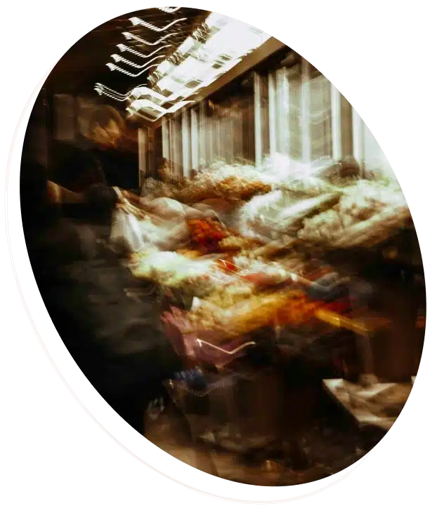 A motion-blurred, abstract image of a crowded market or train.