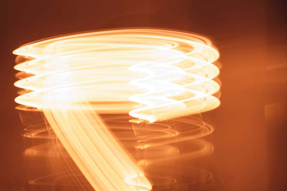 A-motion-blurred,-abstract-image-of-swirling-orange-and-white-light.