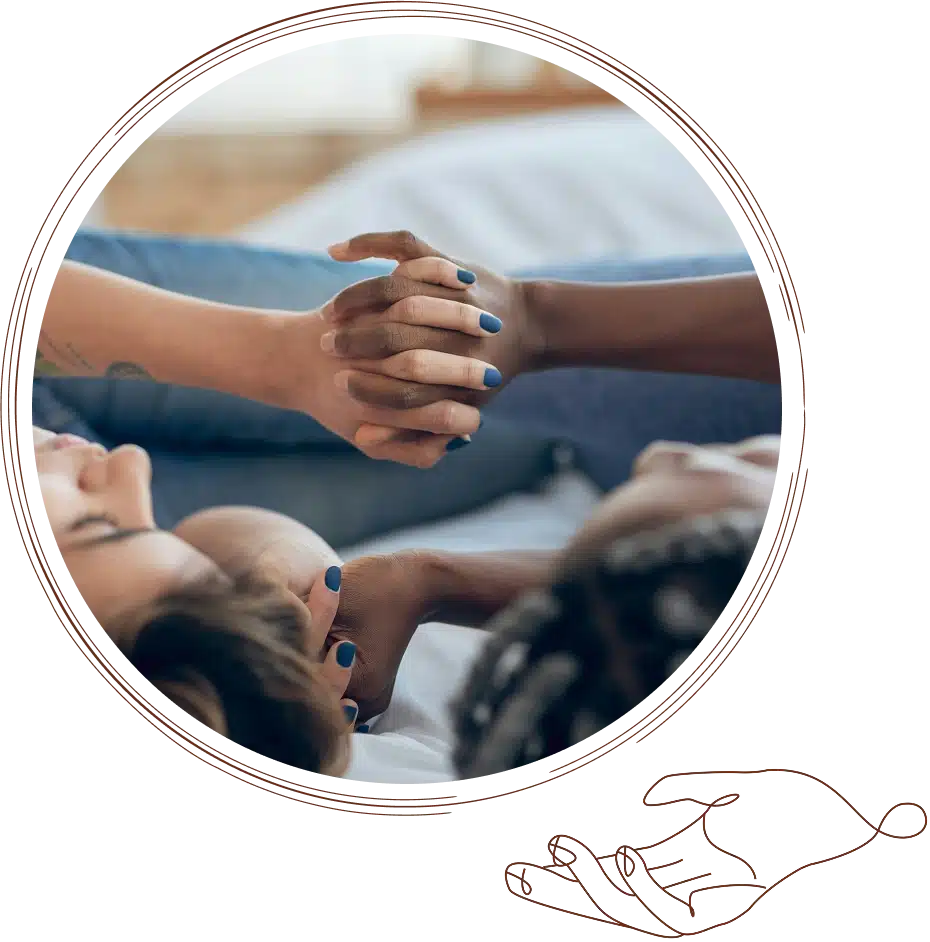 Couples lie down, holding hands.