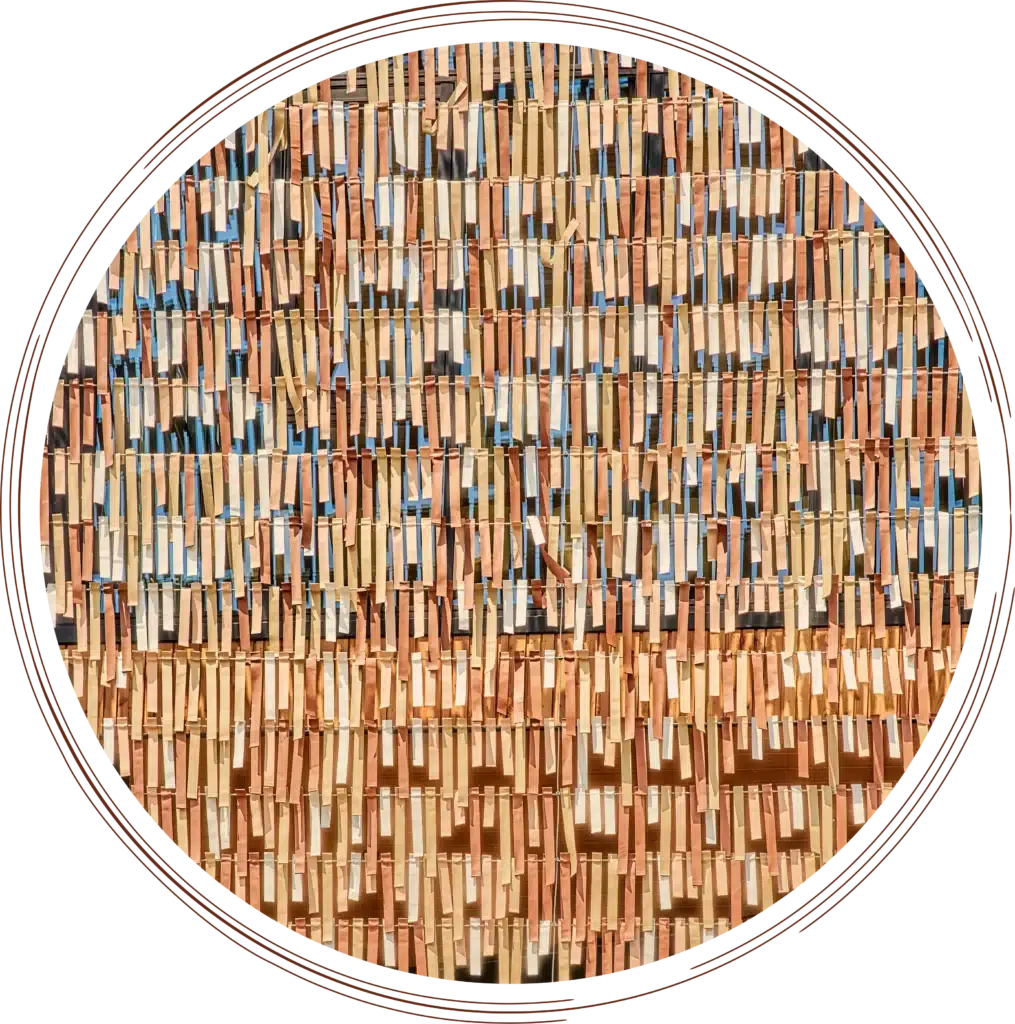 A circular close-up of a modern building facade featuring textured vertical terracotta and beige hanging strips